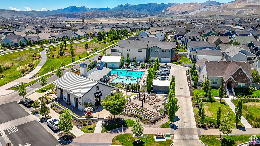 Aerial perspective of suburban area featuring a pool area and a mountain backdrop