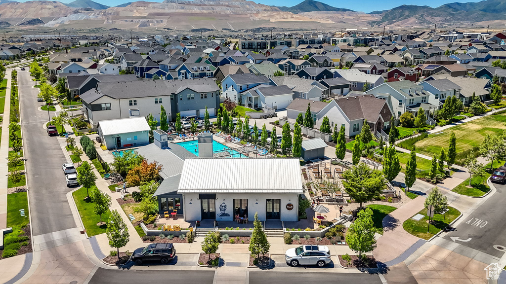 Aerial perspective of suburban area featuring mountains and a pool