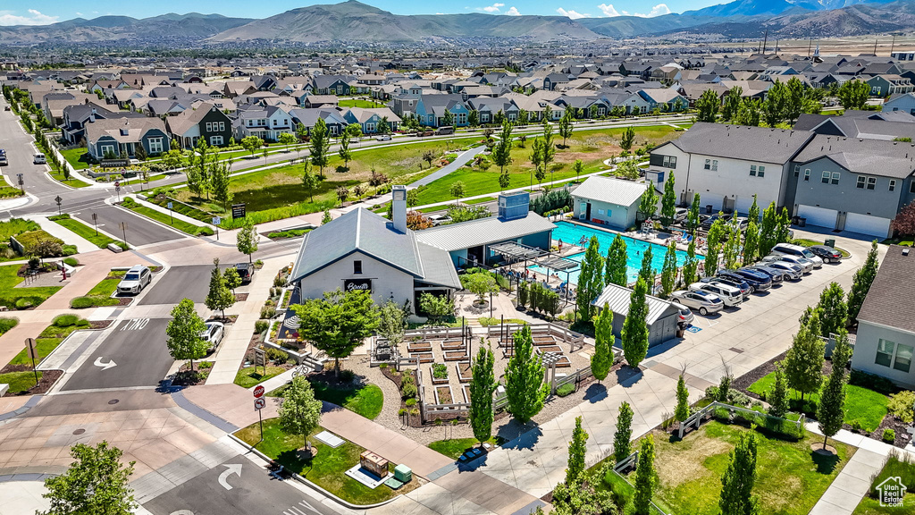 Aerial perspective of suburban area with a pool area and mountains