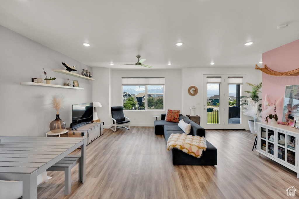 Living area with wood finished floors, recessed lighting, ceiling fan, and baseboards