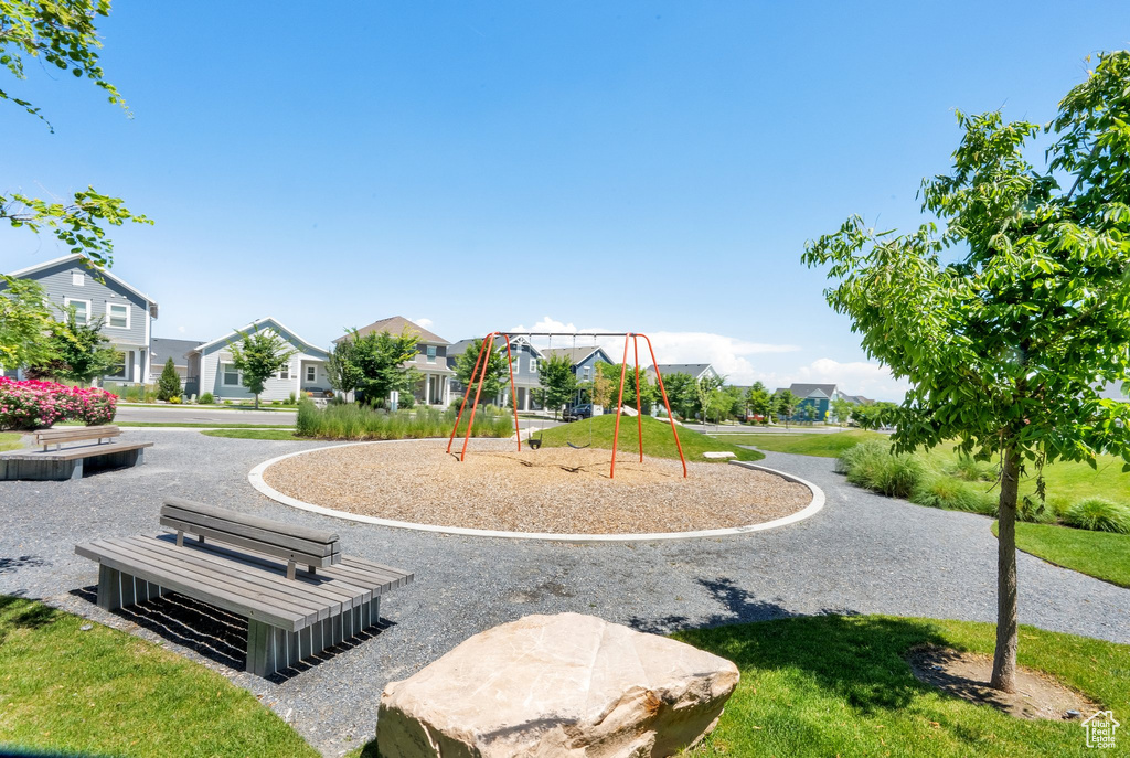 Community play area featuring a residential view and a yard