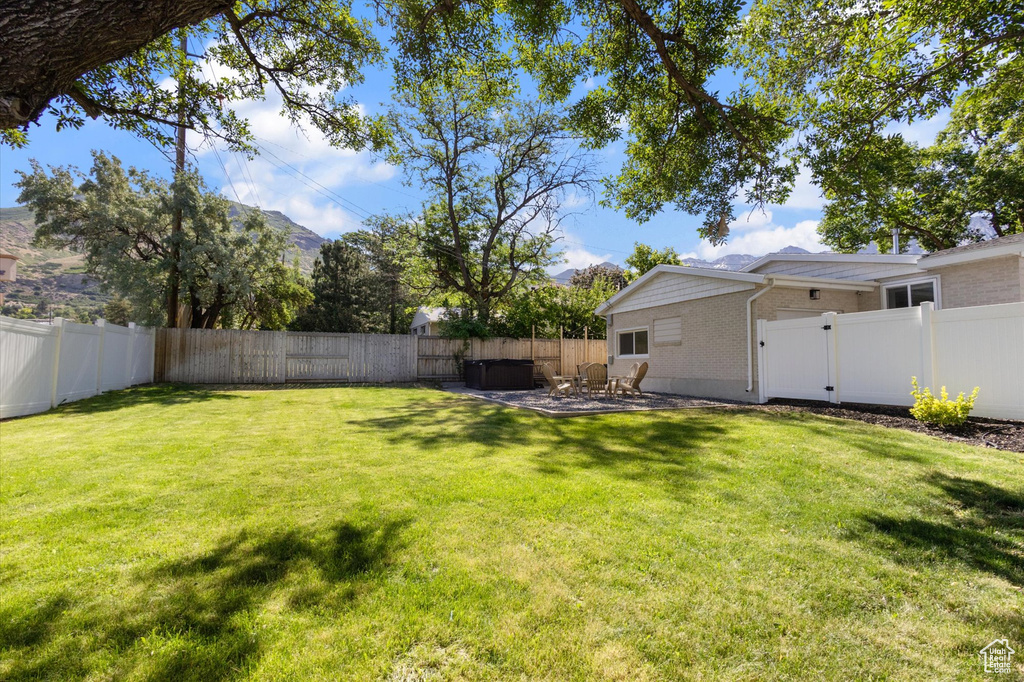 Fenced backyard featuring a patio