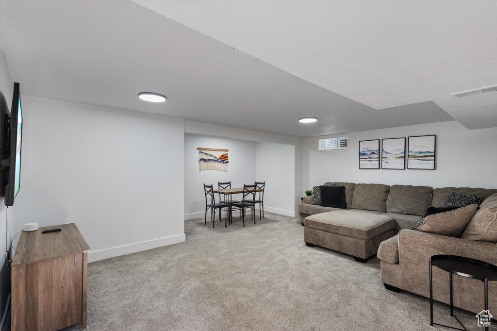 Living area featuring carpet floors and baseboards