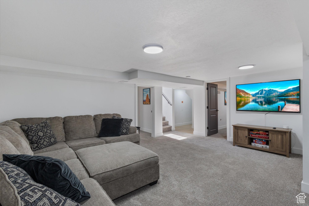 Living area with stairs and carpet