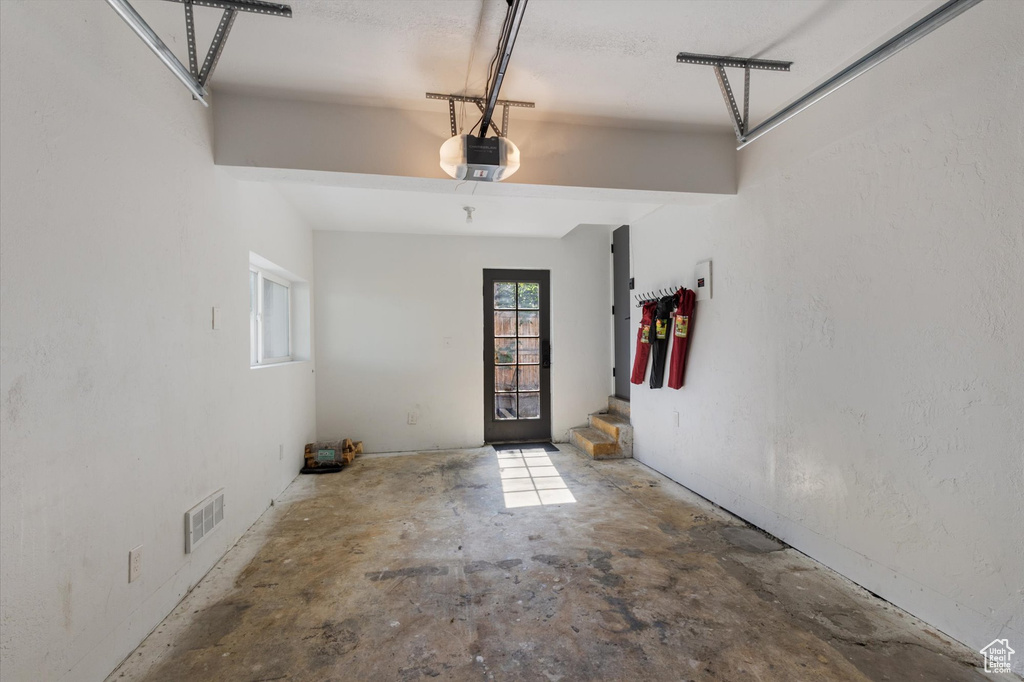 Garage featuring a garage door opener