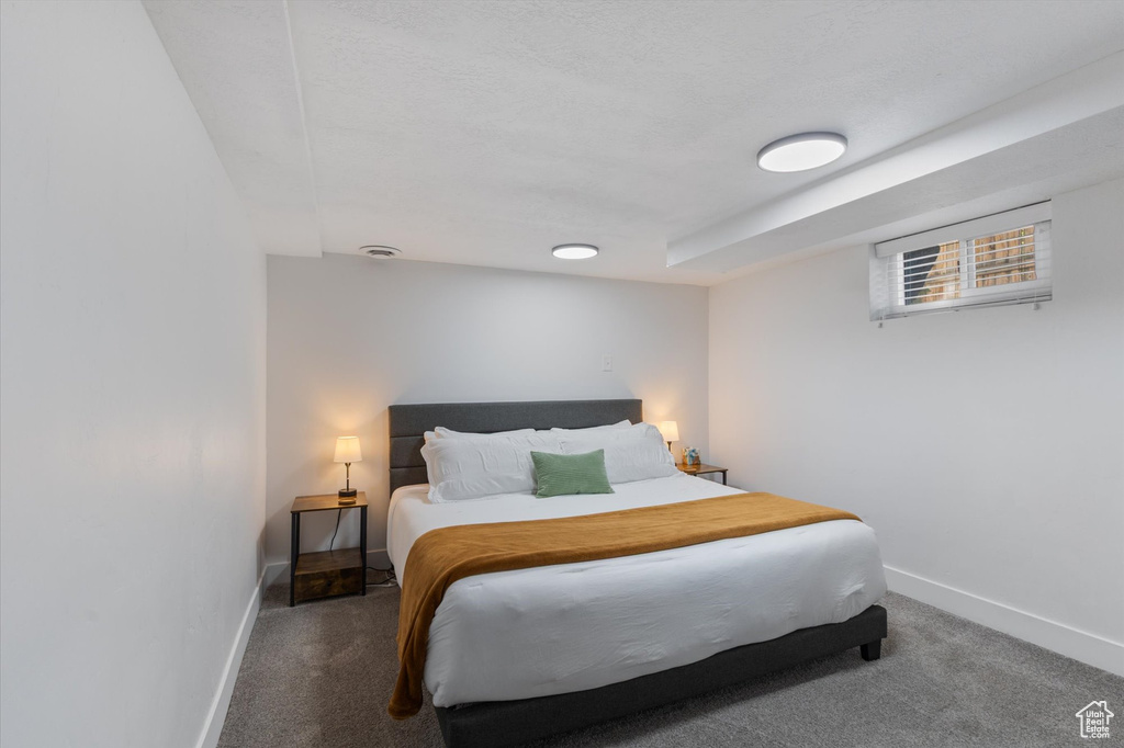 Carpeted bedroom featuring baseboards