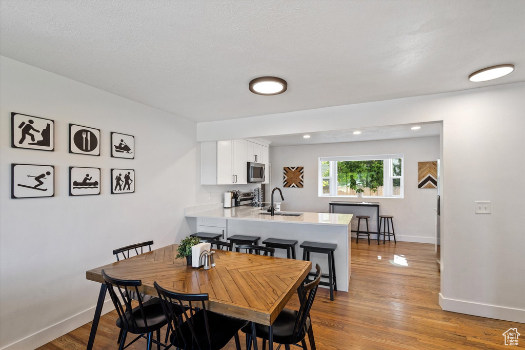 Dining area with wood finished floors and baseboards