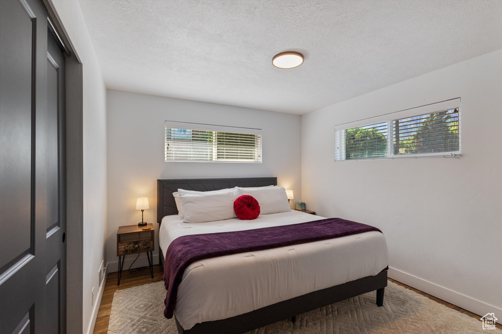 Bedroom featuring wood finished floors and a textured ceiling