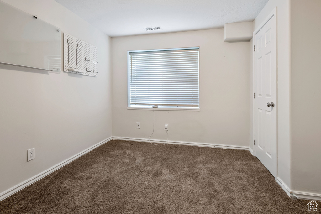 Unfurnished bedroom with carpet and baseboards