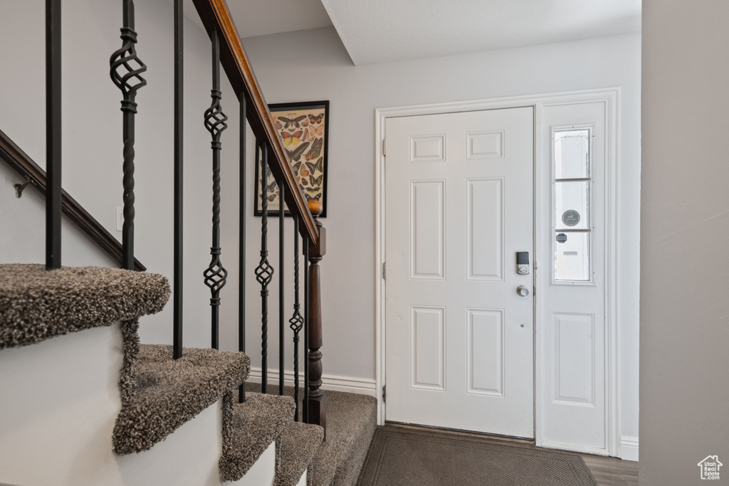 Foyer with stairs and baseboards