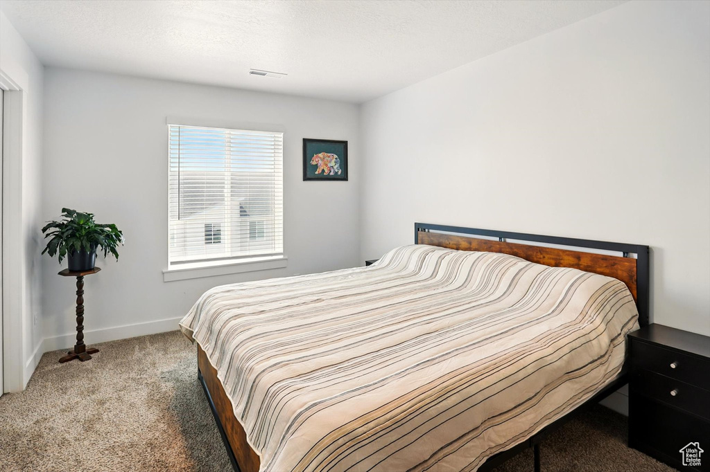 Carpeted bedroom with baseboards