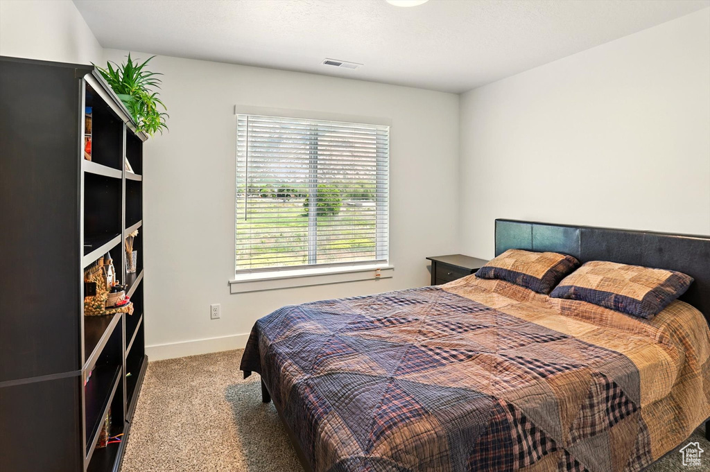 Bedroom with carpet and baseboards
