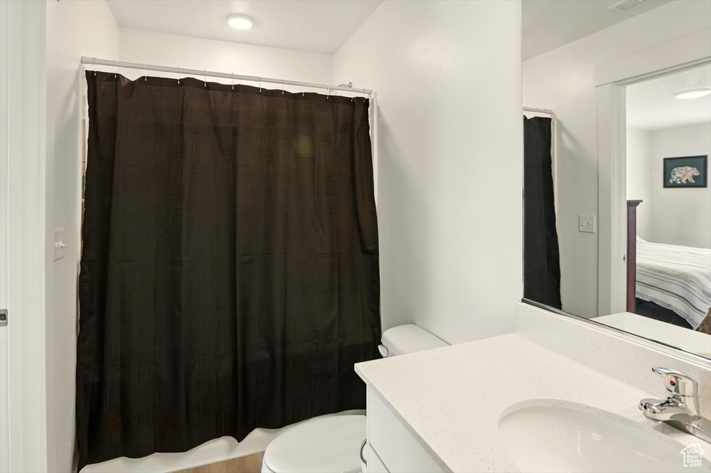 Full bathroom featuring vanity and curtained shower