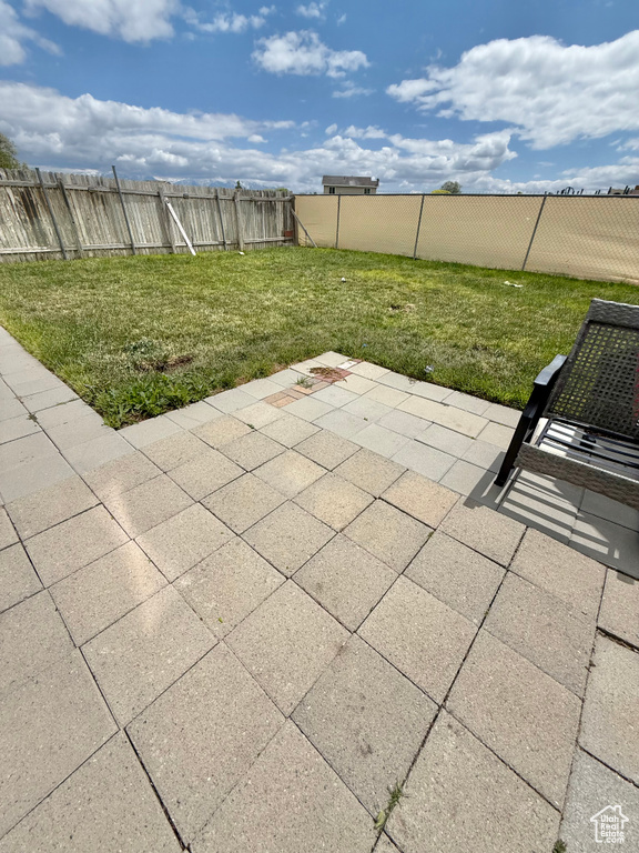Fenced backyard with a patio