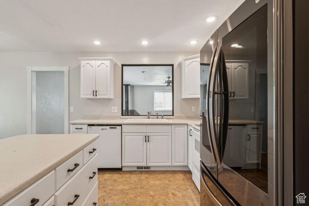 Kitchen with white dishwasher, light countertops, white cabinetry, recessed lighting, and smart refrigerator