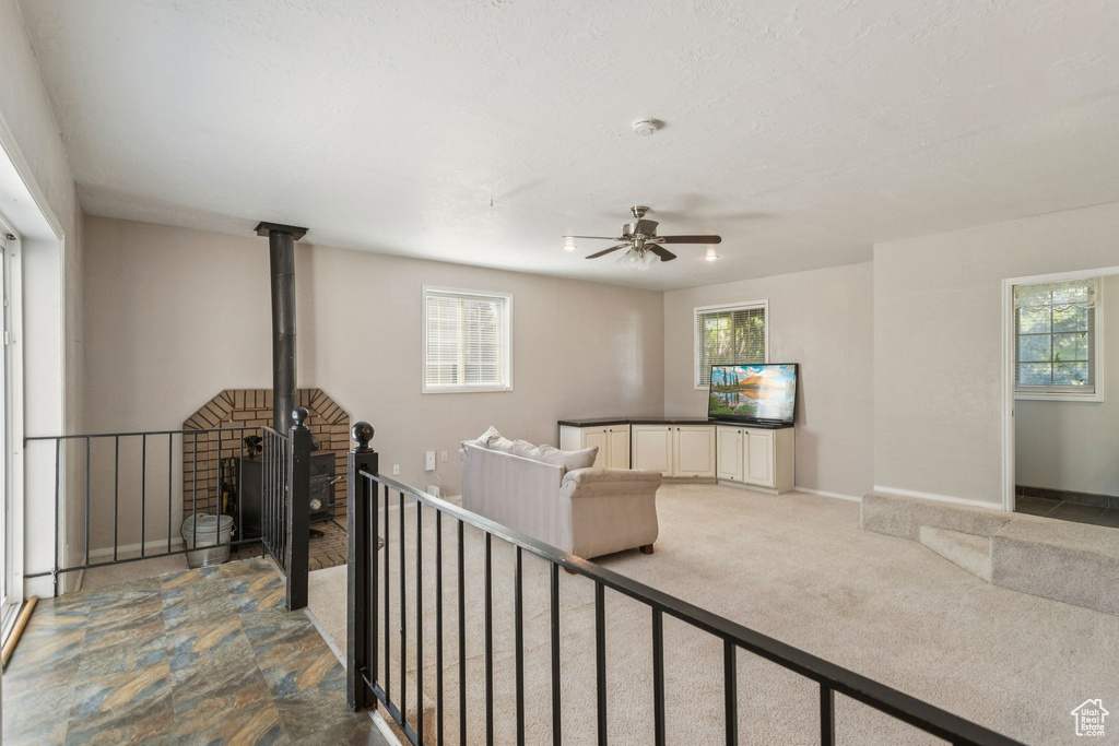 Living area with healthy amount of natural light and ceiling fan