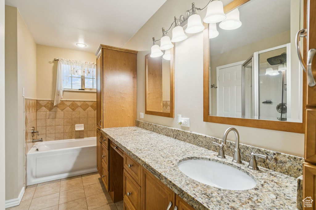 Full bathroom with a garden tub, tile patterned flooring, vanity, and a shower stall