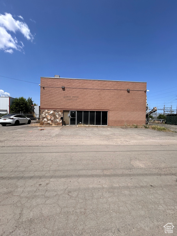 View of property featuring uncovered parking