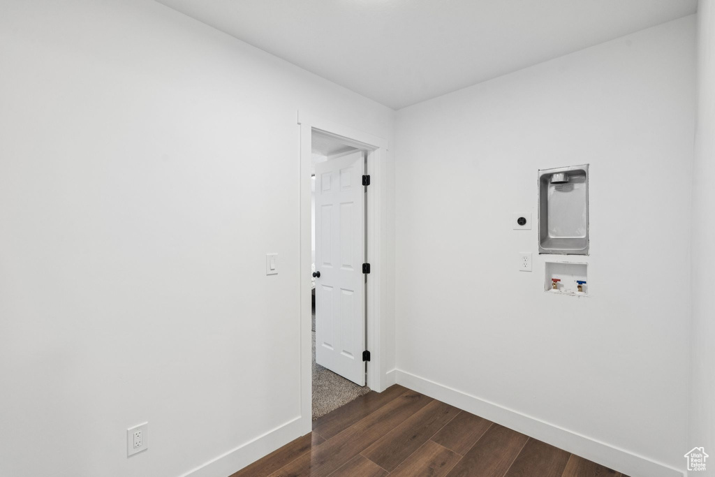 Laundry room with hookup for an electric dryer, baseboards, washer hookup, and dark wood-type flooring