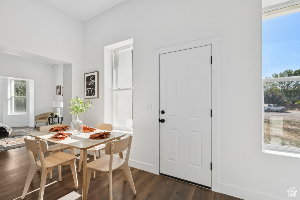 Dining room with dark wood-type flooring and baseboards