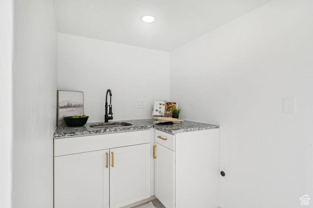 Bar area with a sink and recessed lighting