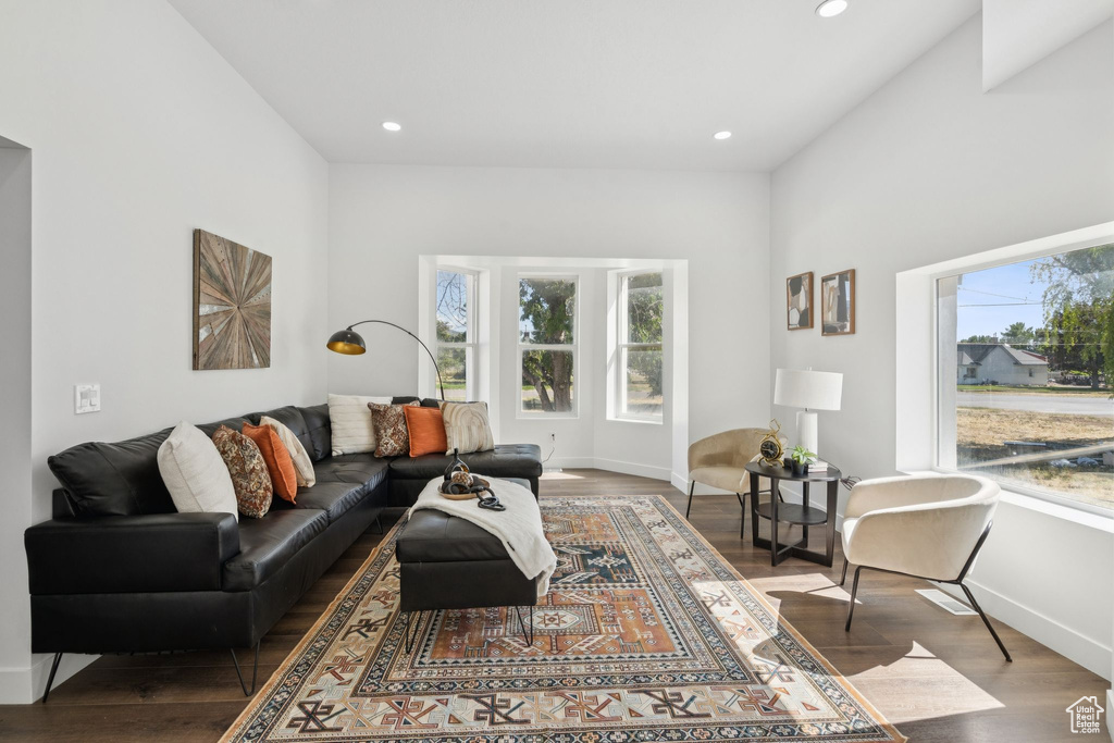Living area with wood finished floors, baseboards, and recessed lighting