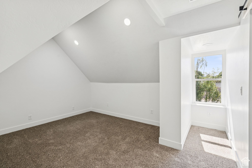 Additional living space featuring vaulted ceiling, carpet, baseboards, and recessed lighting