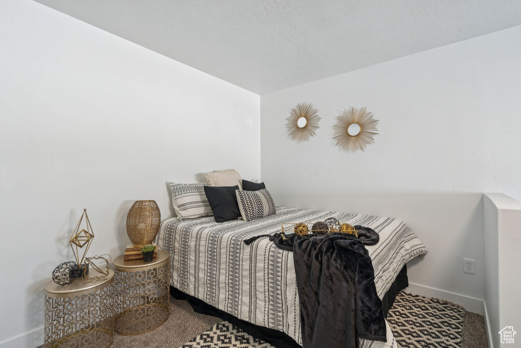 Bedroom featuring carpet floors and baseboards