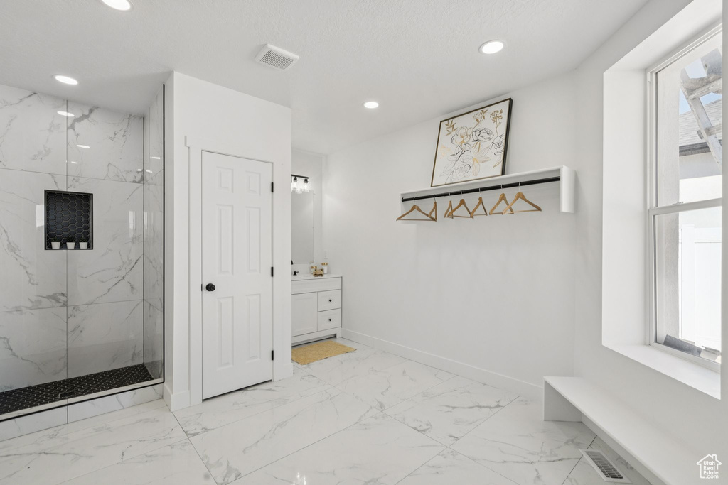 Mudroom featuring light marble finish floors, recessed lighting, and baseboards