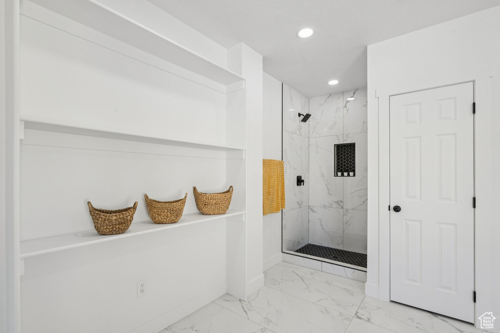 Full bathroom featuring marble finish flooring, a marble finish shower, recessed lighting, and baseboards