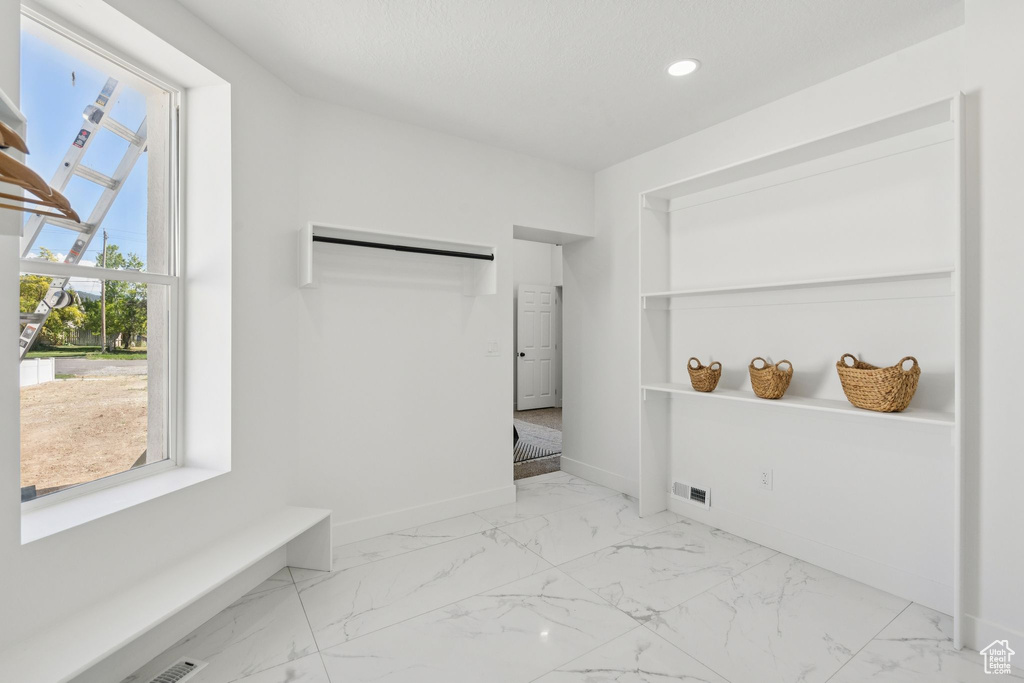 Unfurnished bedroom with baseboards, marble finish floors, and recessed lighting