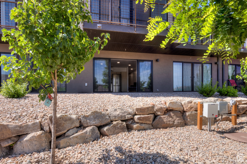 Back of property featuring stucco siding