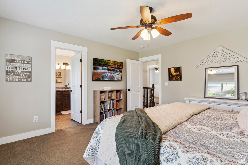 Bedroom with carpet floors, a ceiling fan, and ensuite bath