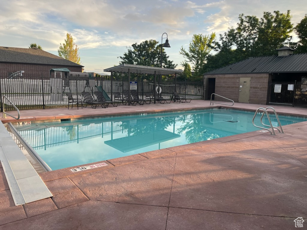 Community pool with a patio