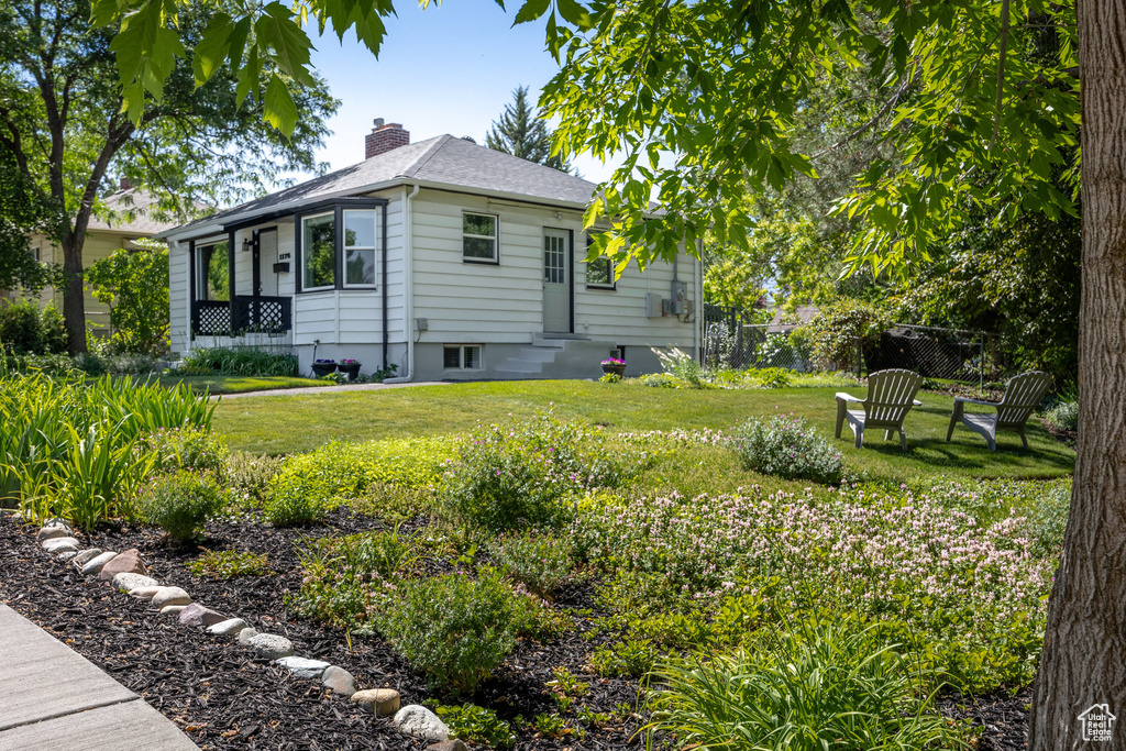 View of property exterior featuring a chimney, entry steps, and a shingled roof
