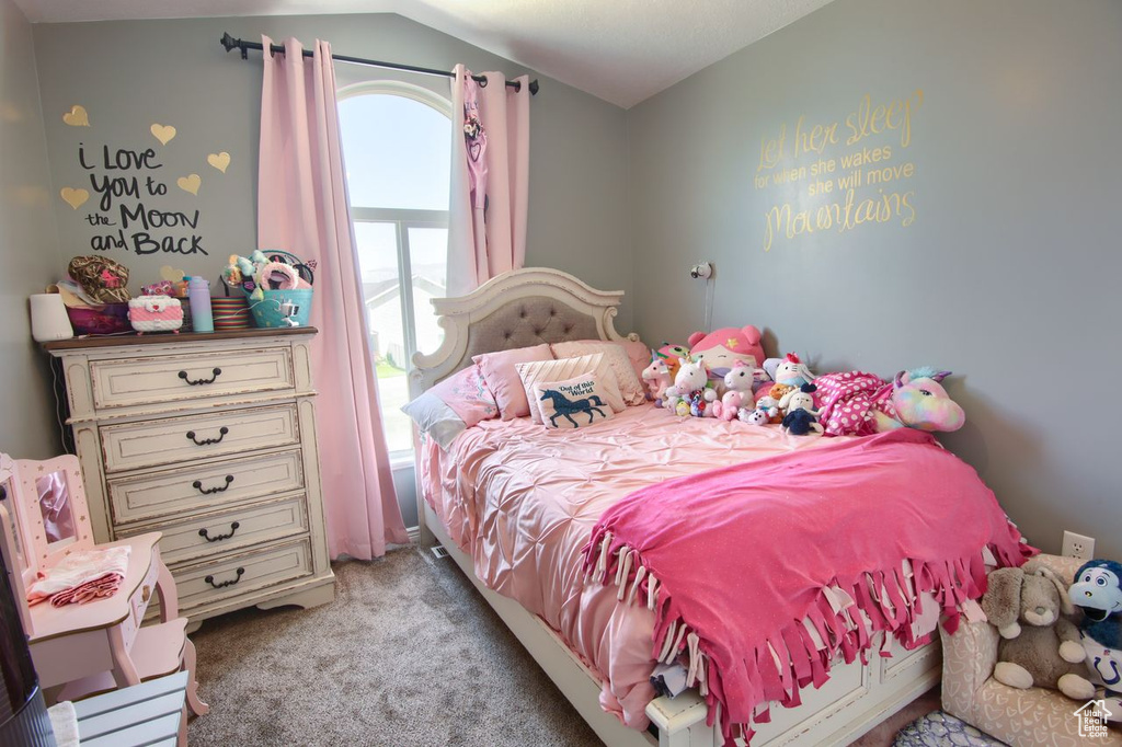 Bedroom with light carpet and lofted ceiling