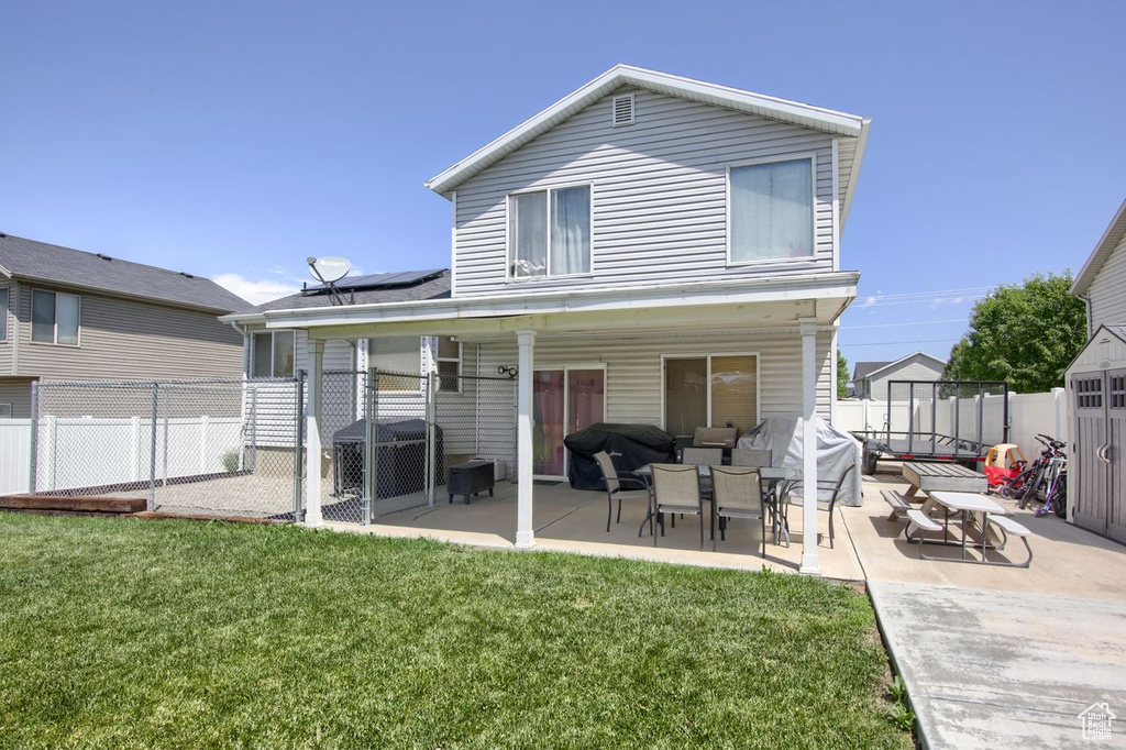 Rear view of property with a patio and a fenced backyard