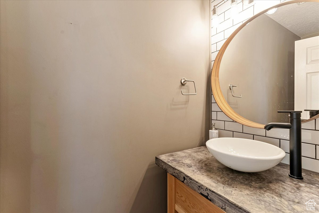 Bathroom featuring vanity and a textured ceiling