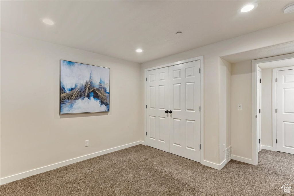 Unfurnished bedroom with carpet floors, recessed lighting, baseboards, and a closet
