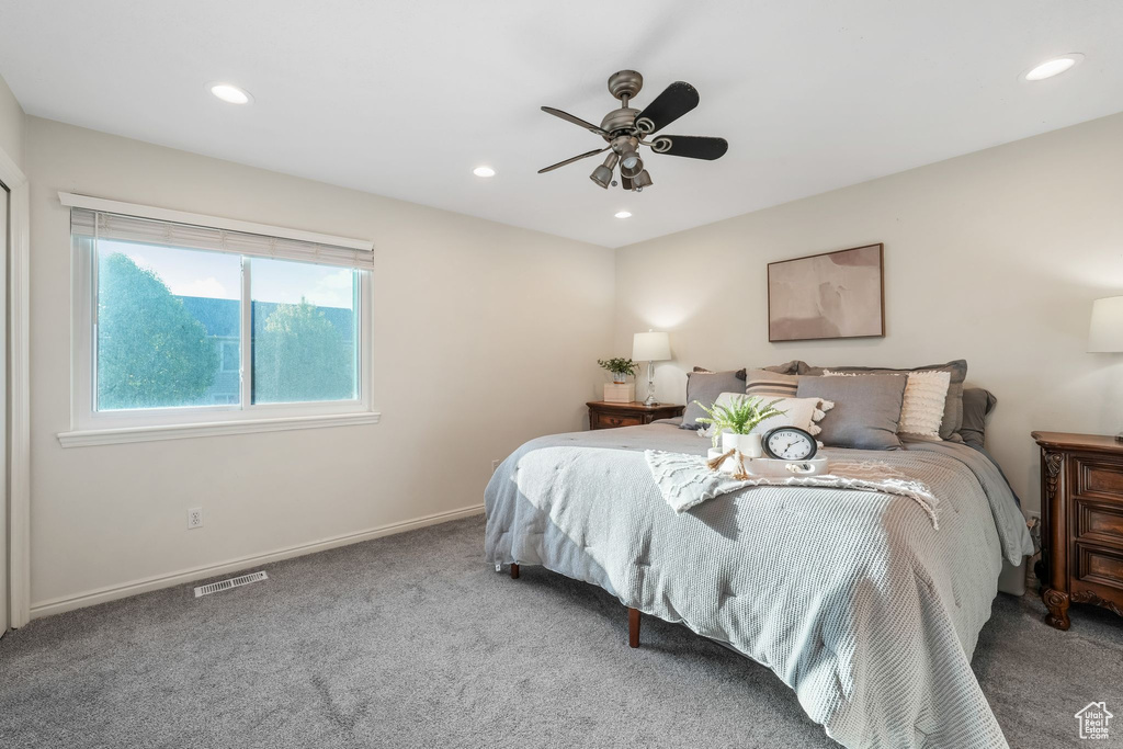 Carpeted bedroom with recessed lighting and a ceiling fan