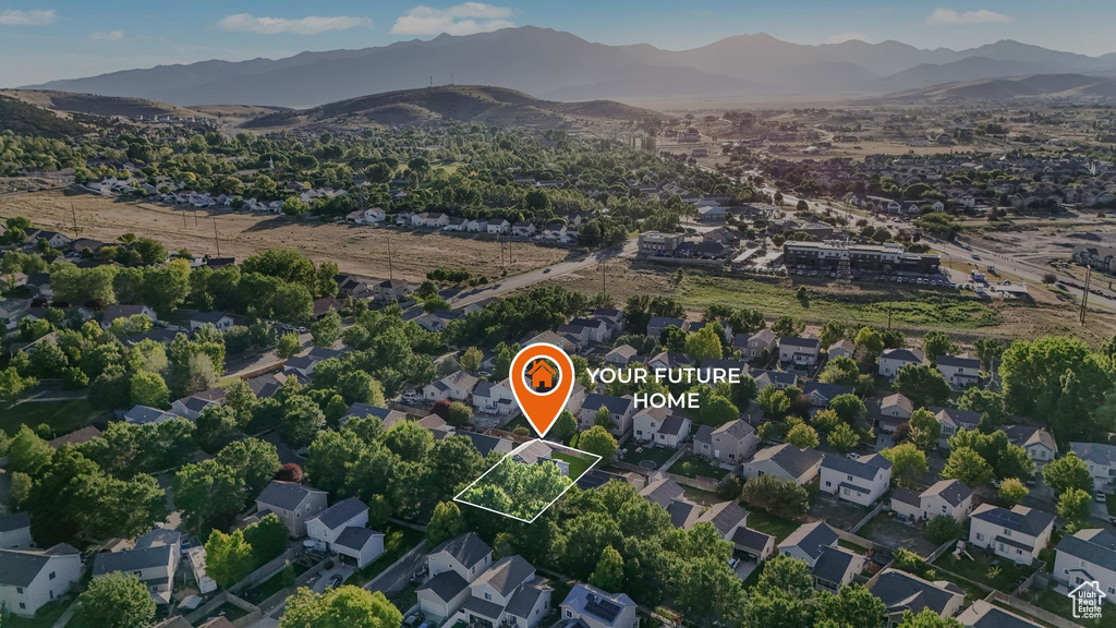 Aerial view of property and surrounding area featuring mountains and property parcel outlined
