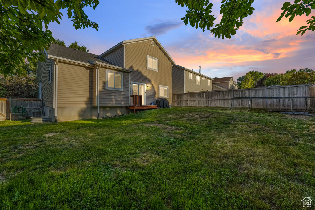 Back of house with a fenced backyard