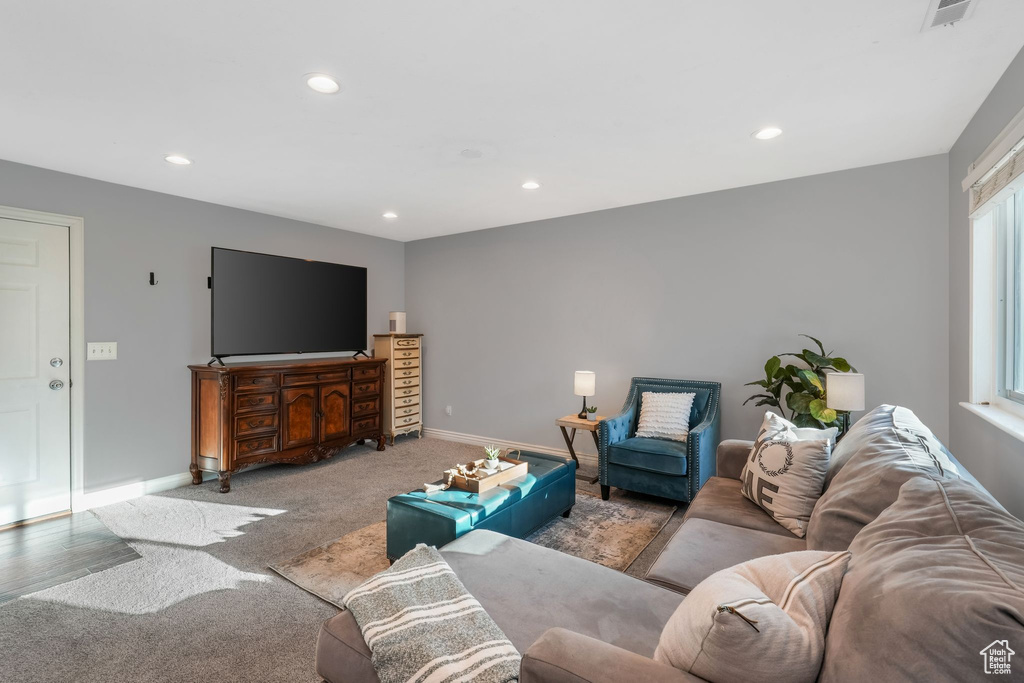 Carpeted living area featuring recessed lighting