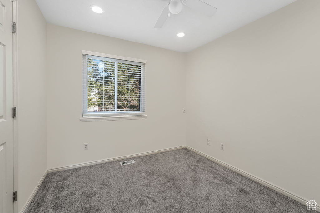 Spare room with carpet, a ceiling fan, and recessed lighting