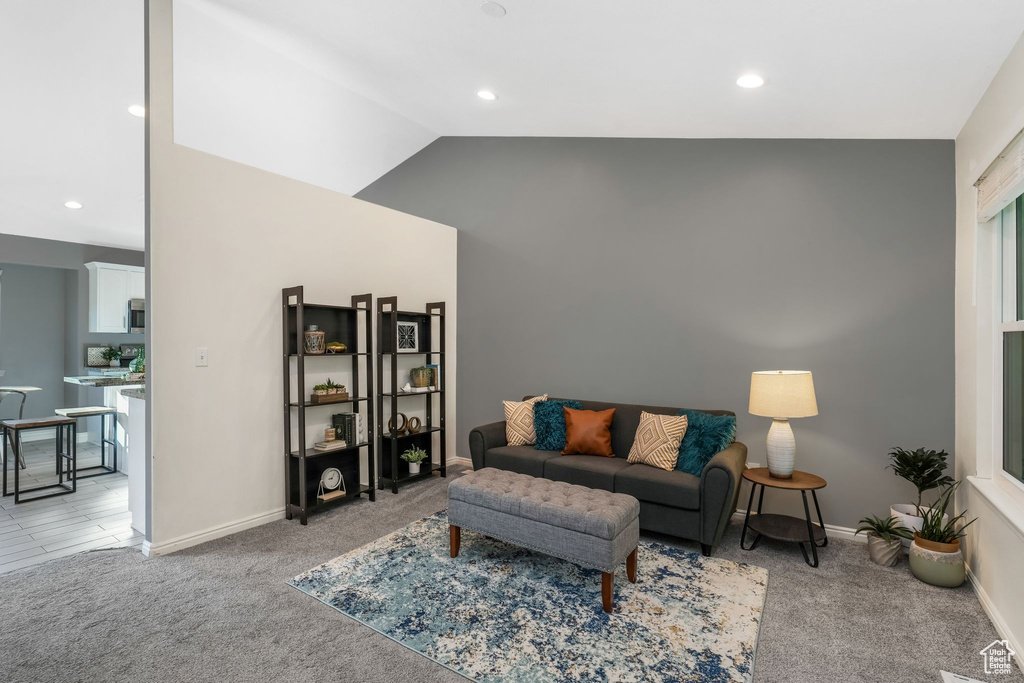 Living area featuring light colored carpet, recessed lighting, and lofted ceiling