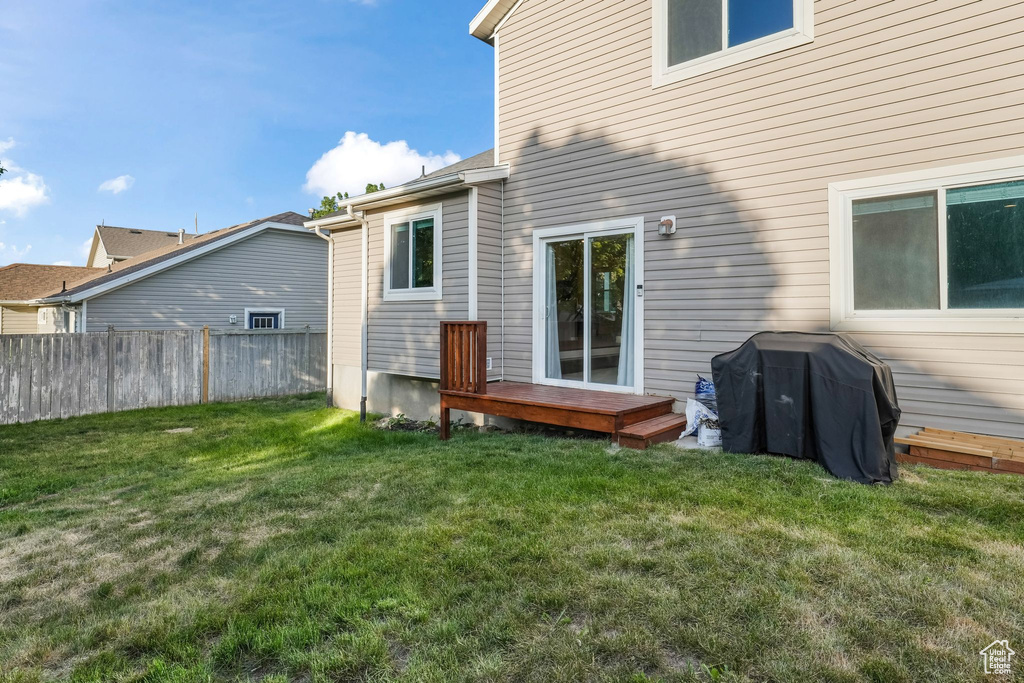 Rear view of house with a wooden deck