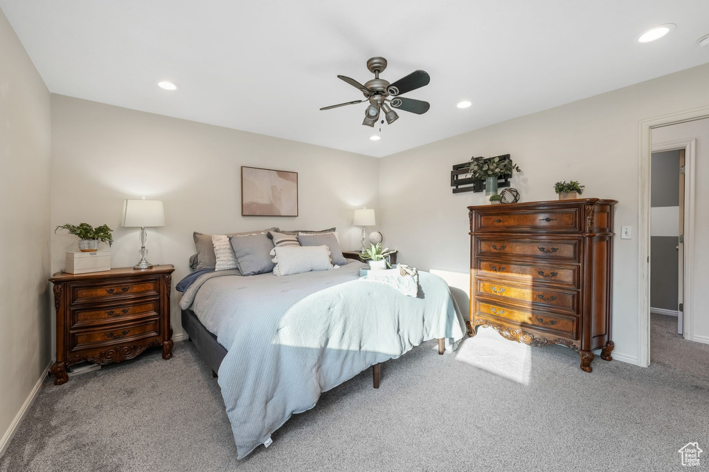 Bedroom featuring light colored carpet, a ceiling fan, and recessed lighting