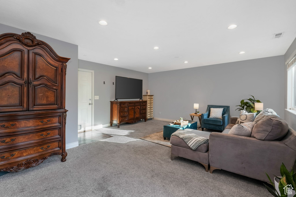 Living area featuring light carpet and recessed lighting