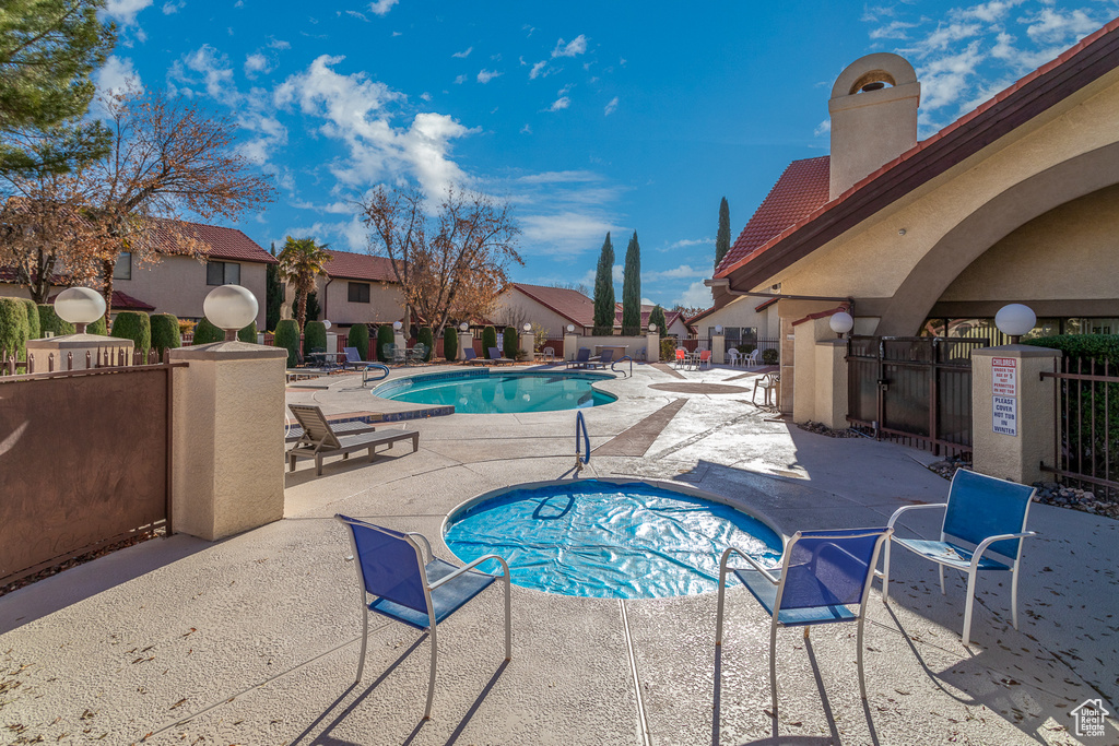 Community pool with a patio and a residential view
