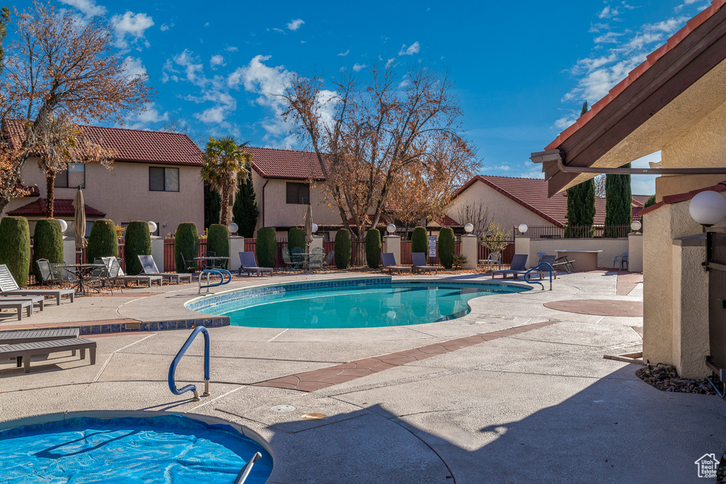 Community pool with a patio